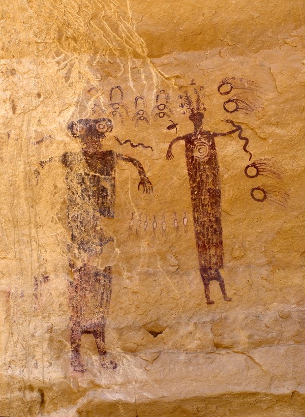 Head of Sinbad figure with a headdress, small birds and a snake, beside a faded figure