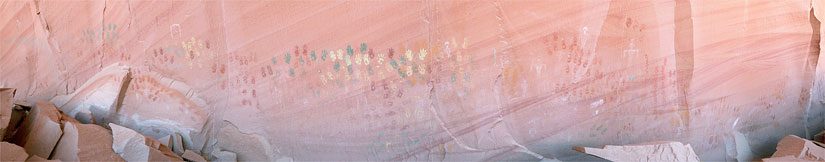 Long wall covered with rows of handprints