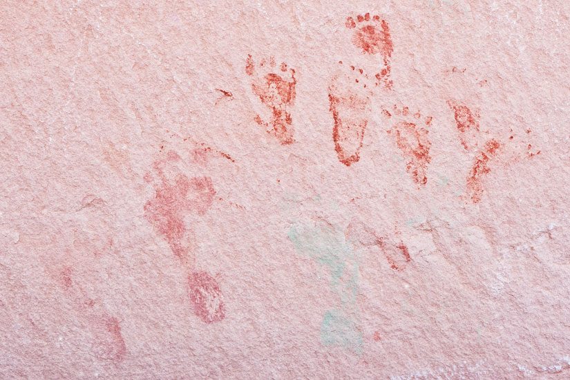 Red painted adult and child footprints