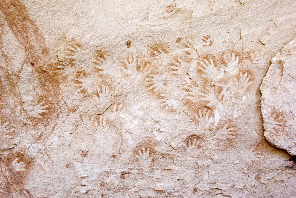 Negative handprints outlined in sprayed paint
