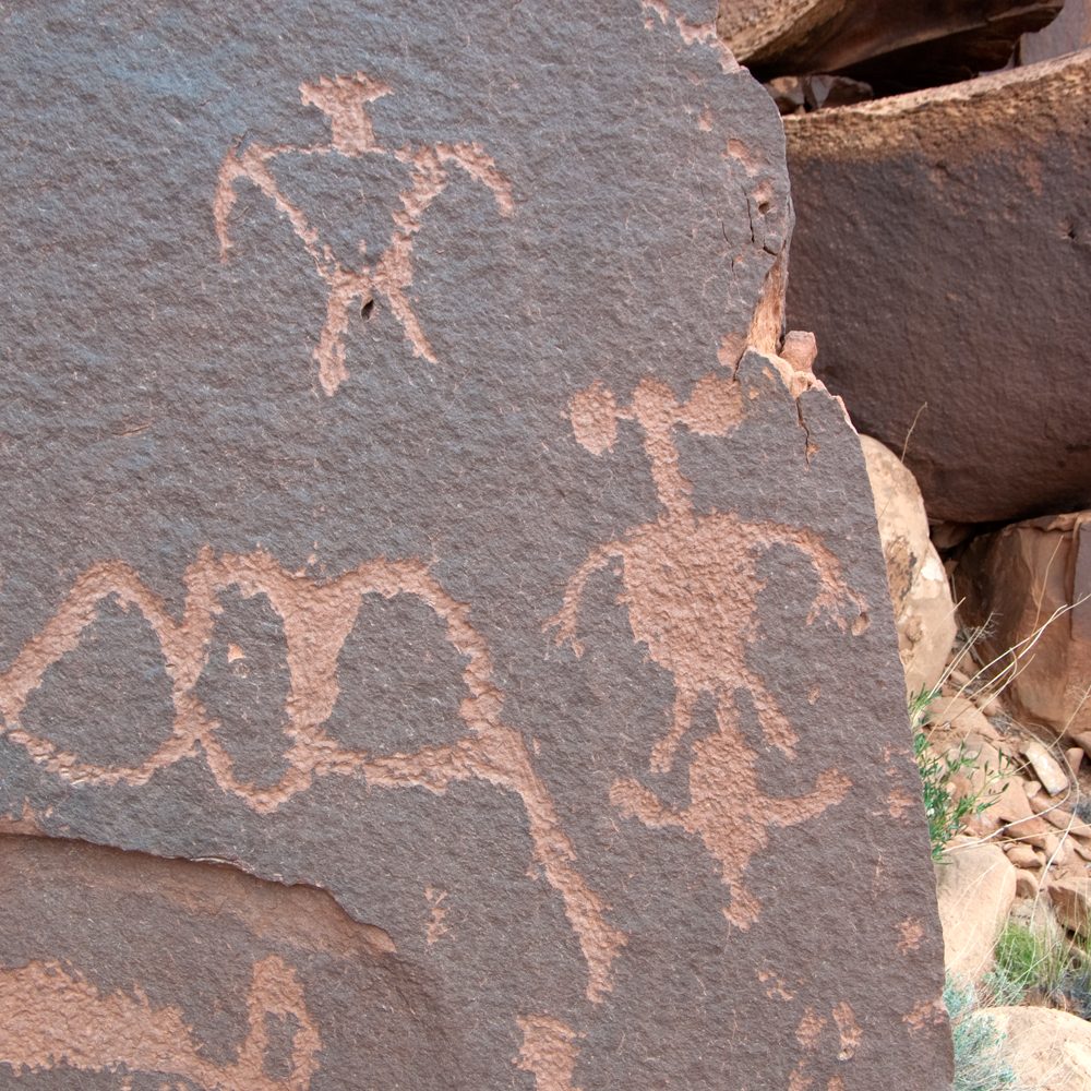 Petroglyphs of mothers with squash blossom hairstyles