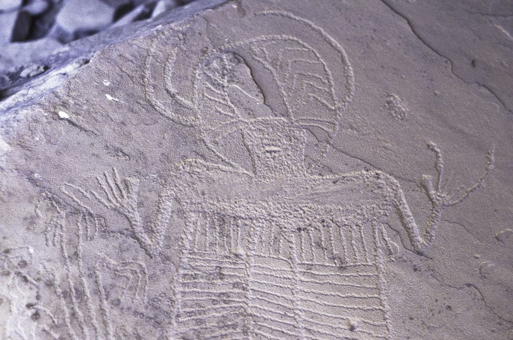 Interior Line Style petroglyph of a figure with a headdress and line-filled body