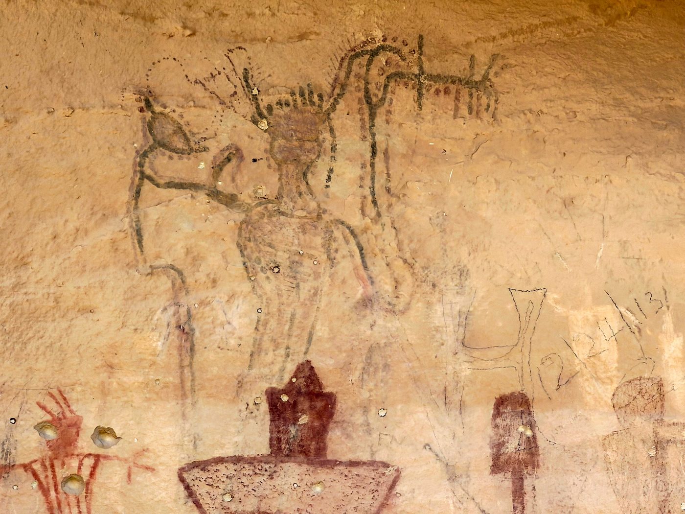 Faded outlined figure with Fremont figures painted over it