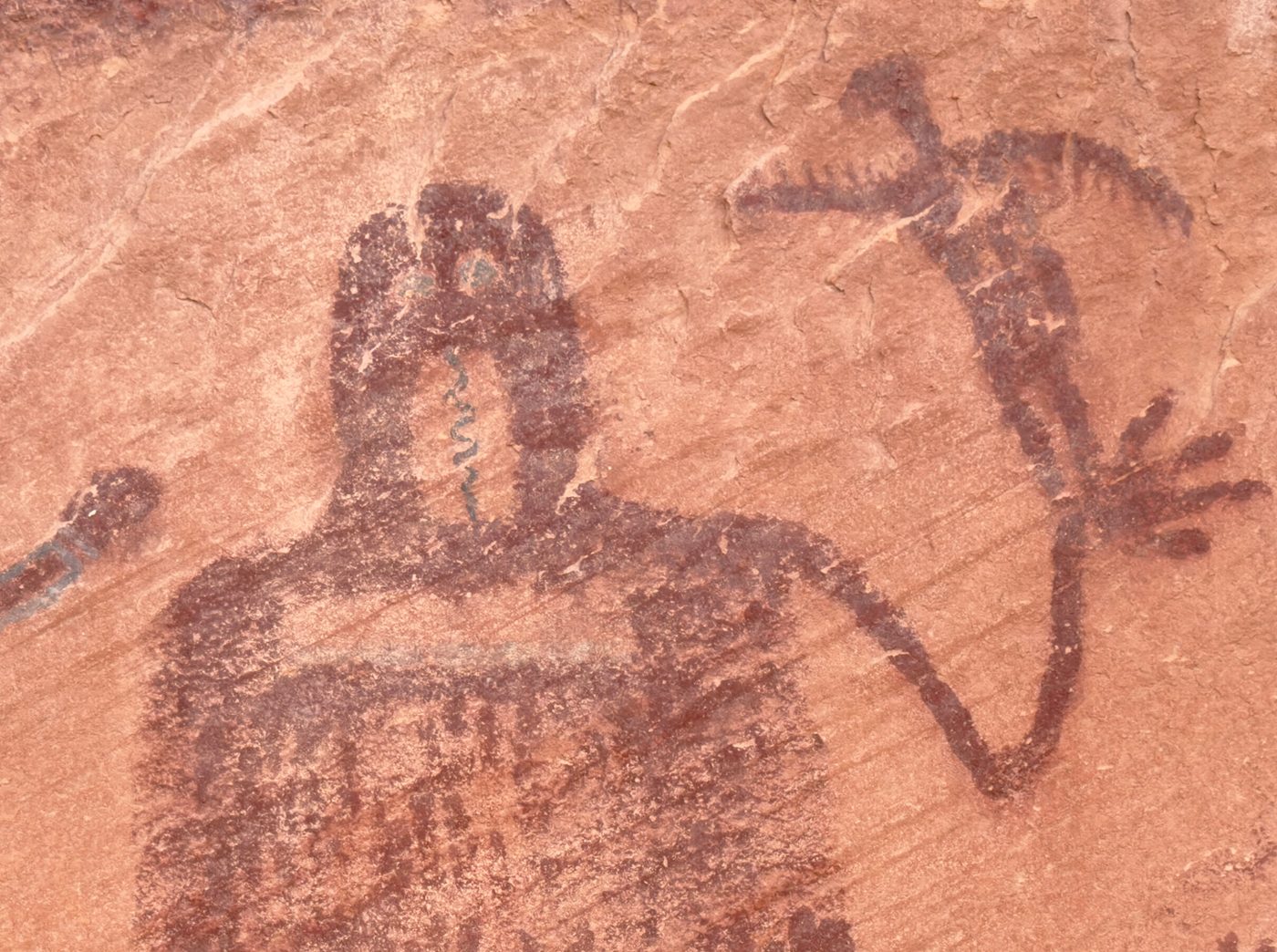 Close view of the Snake In Mouth figure with a bird-like form at its hand